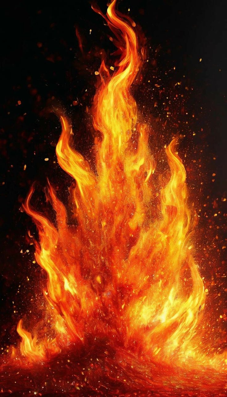 A tall column of fire rising against black, throwing sparks.